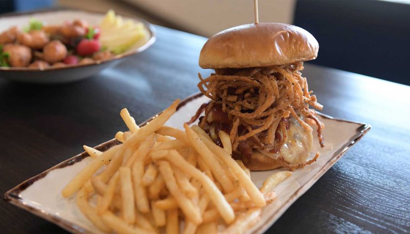 Burger on plate at The Rivers restaurant at Holiday Inn & Conference Center in Marshfield WI