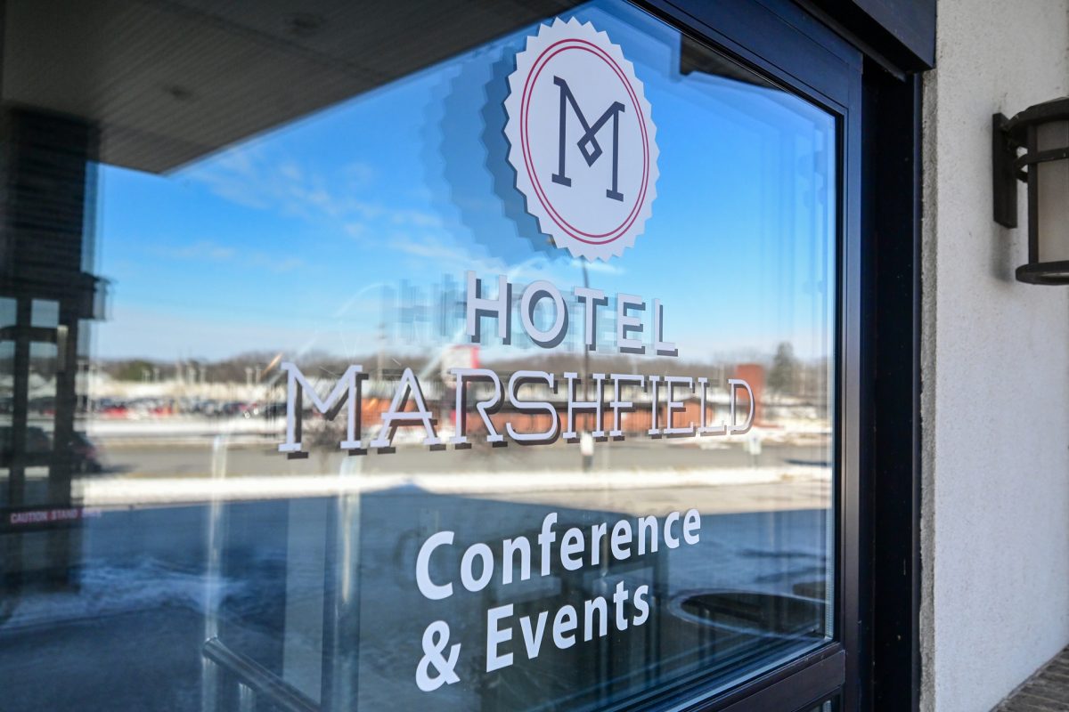 4 reasons to host your event in Marshfield in central Wisconsin | Sign on window at Hotel Marshfield in Marshfield Wisconsin advertising conferences and events