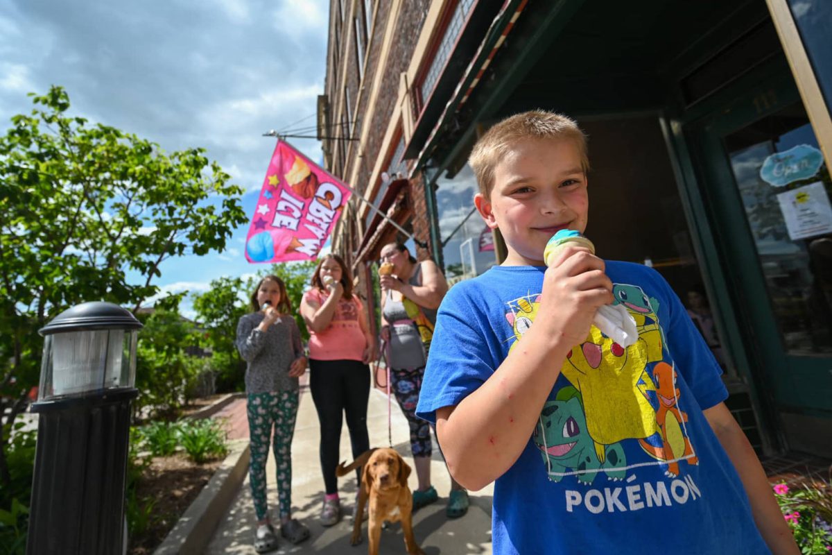 Family eating ice cream outside Hub City Ice Cream in downtown Marshfield W