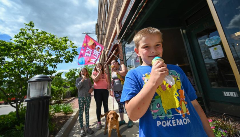 Family eating ice cream outside Hub City Ice Cream in downtown Marshfield W