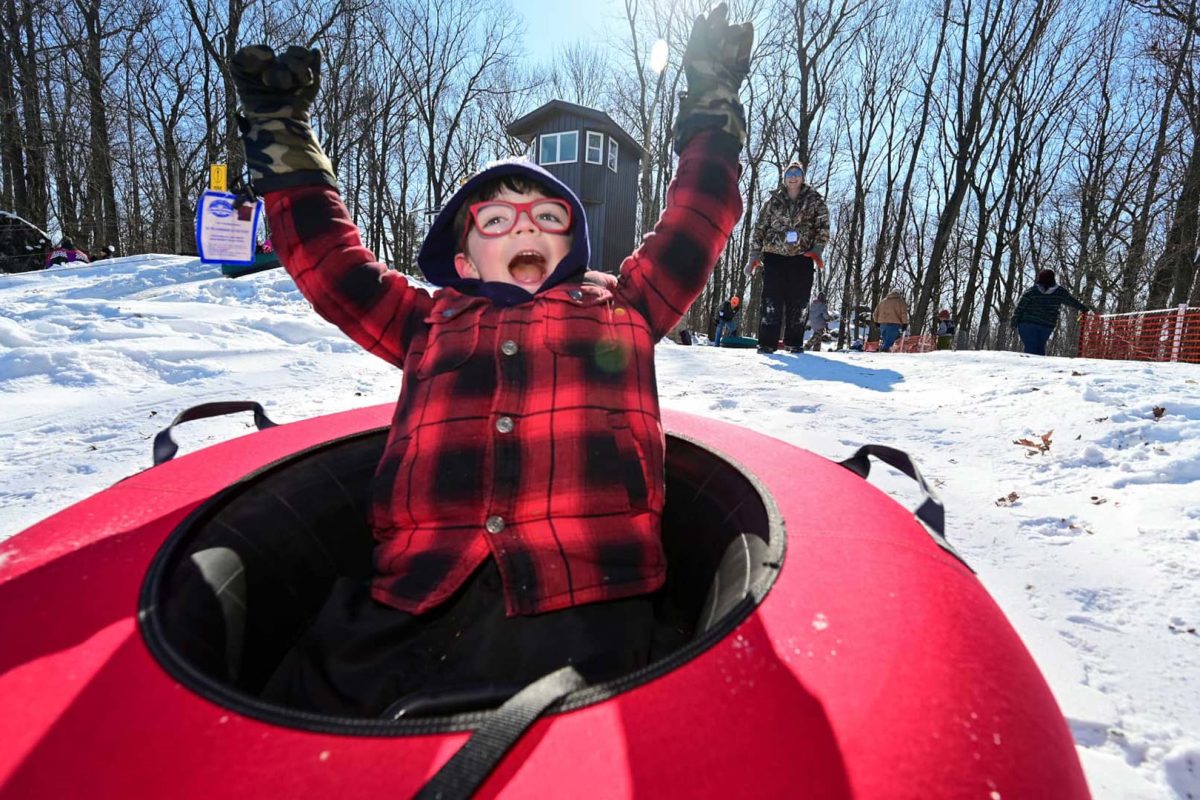 Enjoy this 3-day getaway to Marshfield in central Wisconsin | Child on inner tube at tubing hill at Powers Bluff County Park in Wood County Marshfield Wisconsin